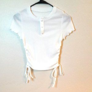 Cider White Top with Drawstring sides. Pearl front buttons. Ruffle sleeve edge.